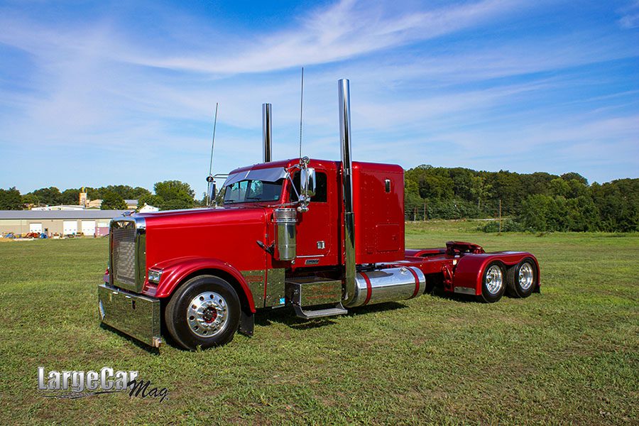 Safety and Compliance - VView of Red Truck Parked on Green Grass Against a Blue Sky
