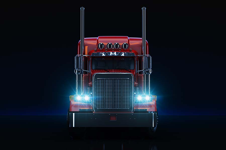 We Are Independent - Closeup View of the Front of a Modern Red Truck with Blue Front Headlights on a Black Background